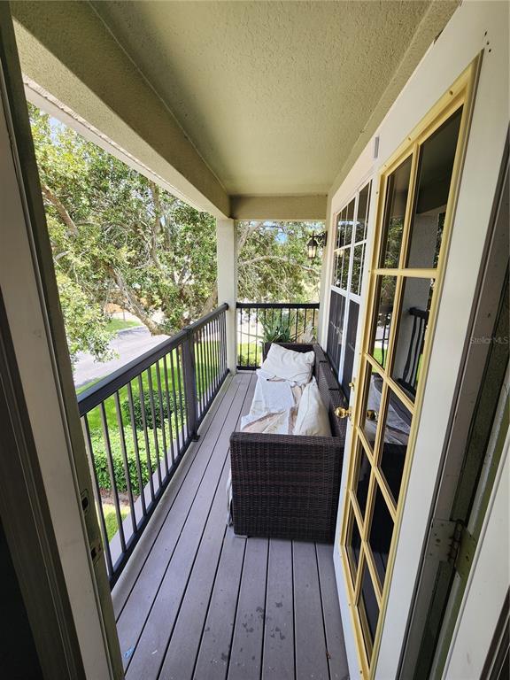 546 Climbing Ivy Court, Unit C Apopka, FL 32712 - Photo 24 of 26 a view of a balcony with wooden floor