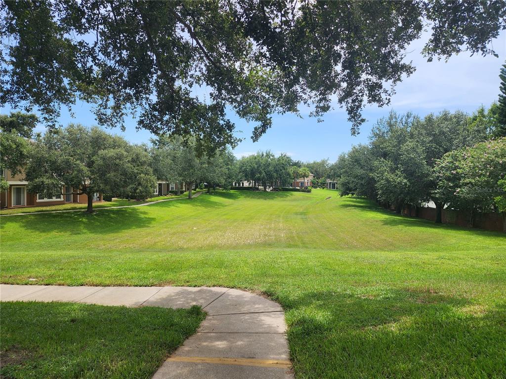 546 Climbing Ivy Court, Unit C Apopka, FL 32712 - Photo 3 of 26 a view of a golf course with a garden