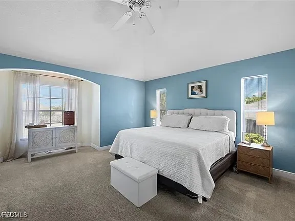 a spacious bedroom with a bed and a couch