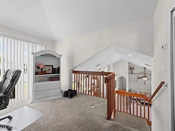 a view of a livingroom with furniture and staircase