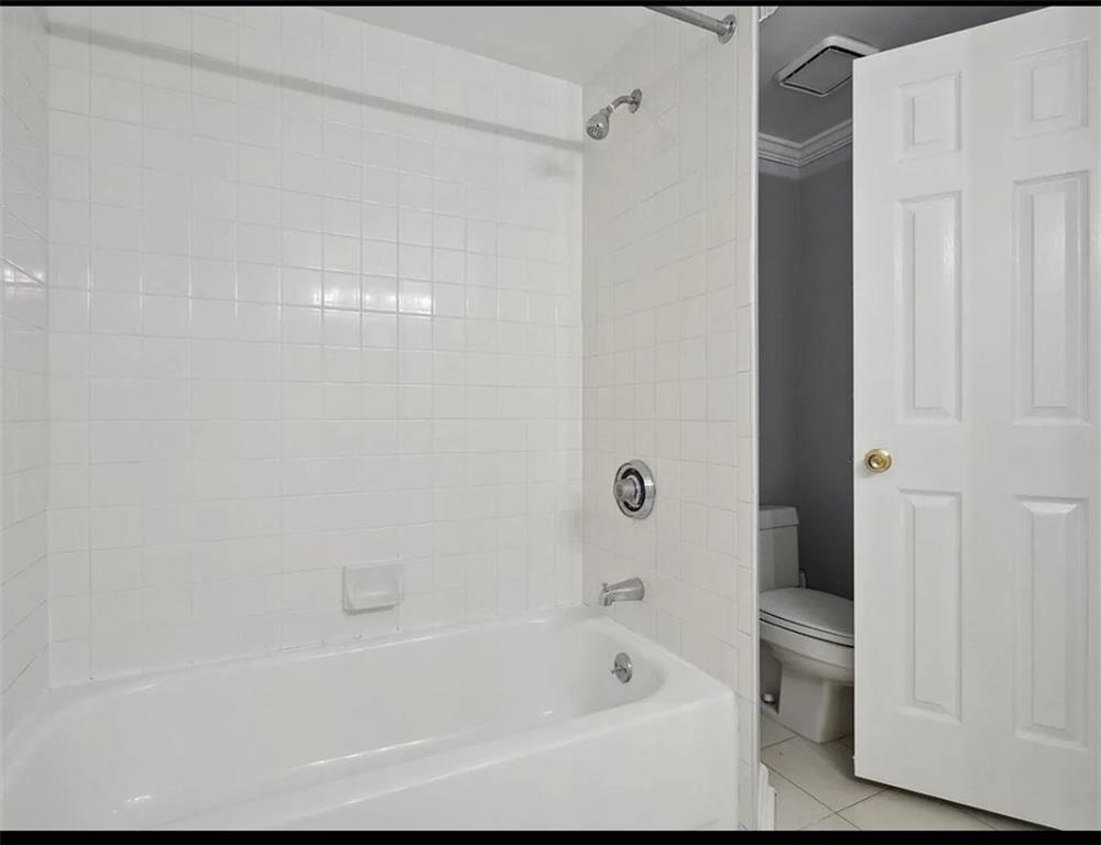 199 14th Street Northeast, Unit 210 Atlanta, GA 30309 - Photo 5 of 12 a bathroom with a bathtub