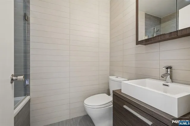 a white toilet sitting next to a white sink