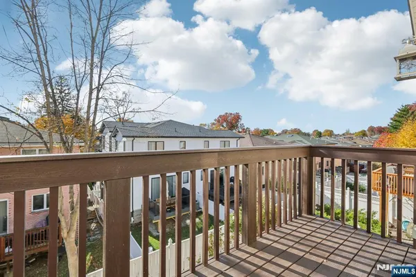 a view of a balcony with wooden fence
