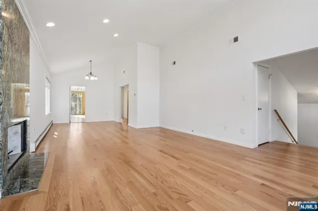 a view of an empty room and wooden floor