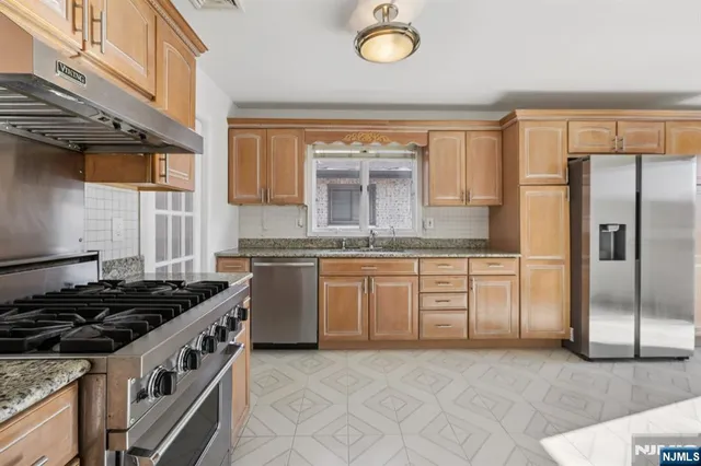 a kitchen with a stove a sink and a refrigerator