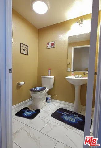 a bathroom with a toilet and a mirror