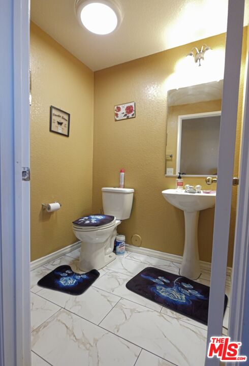 11532 Autumn Street Adelanto, CA 92301 - Photo 13 of 32 a bathroom with a toilet and a mirror