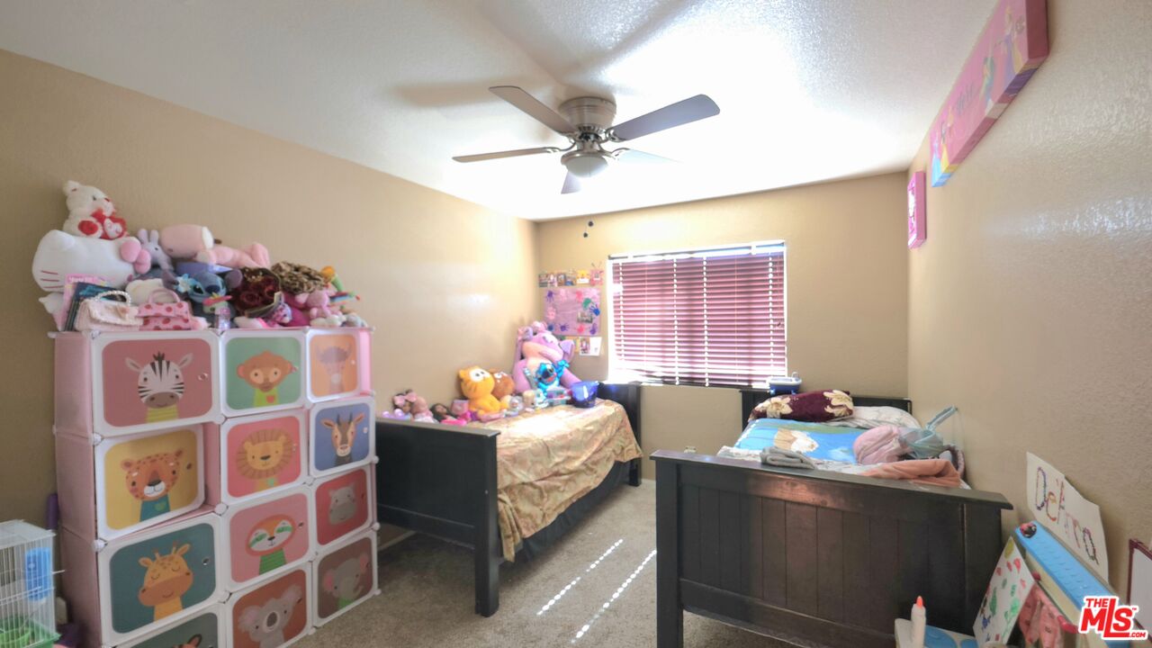 11532 Autumn Street Adelanto, CA 92301 - Photo 18 of 32 a bedroom with a bed and a window