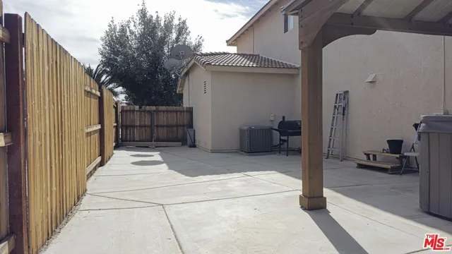a view of a house with a backyard and trees