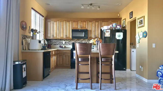 a kitchen with a refrigerator and a sink