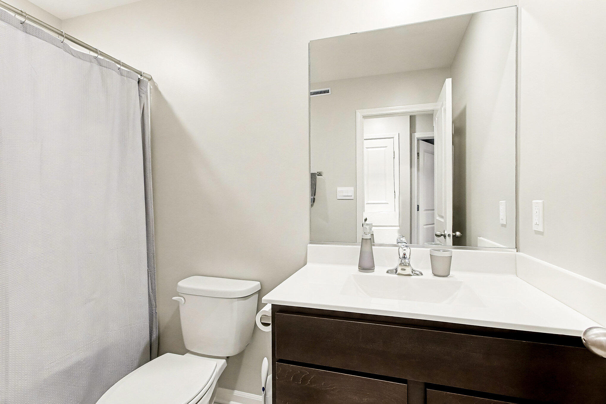 8690 Larkspur Lane St. John, IN 46373 - Photo 16 of 21 a bathroom with a sink a toilet a mirror and shower