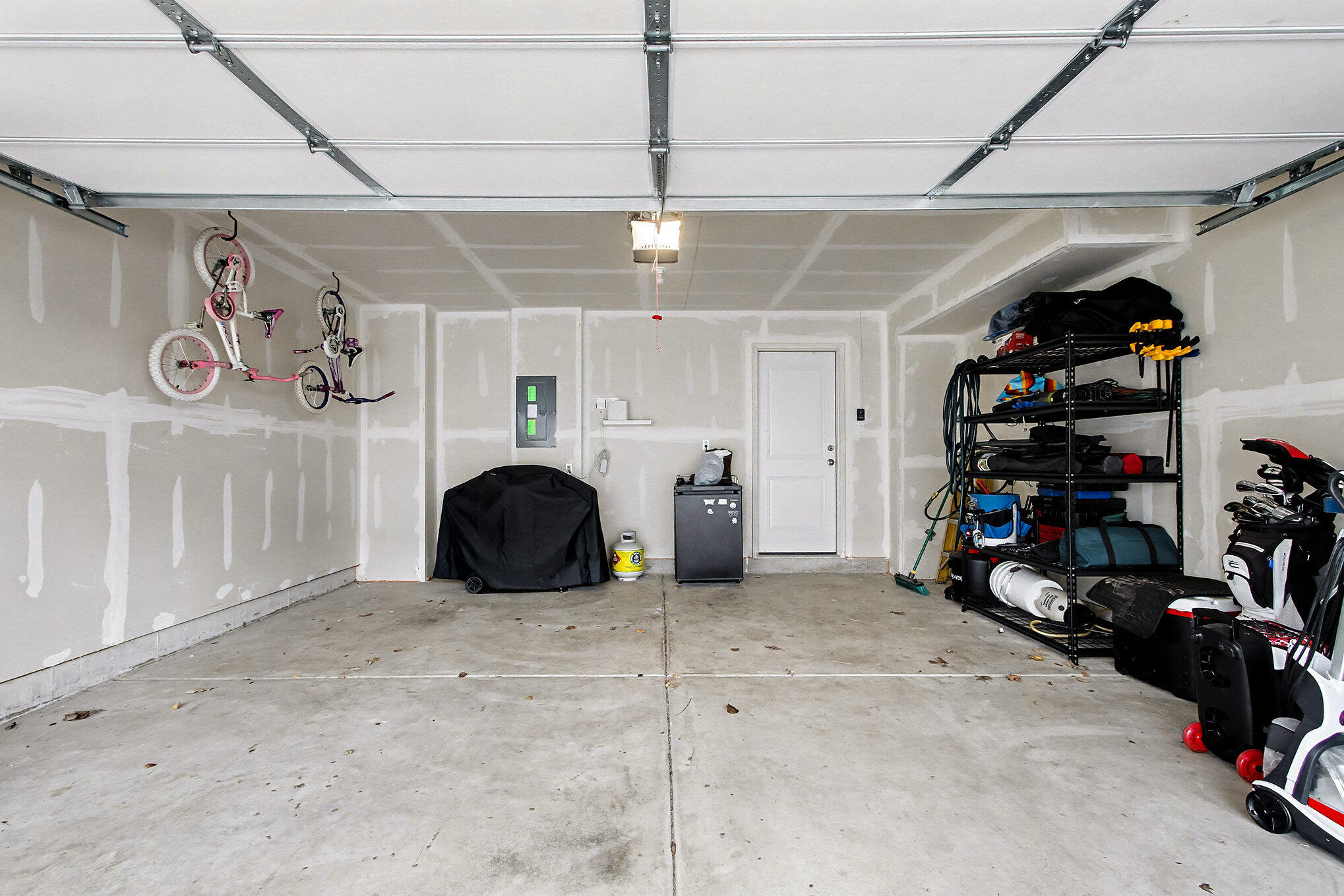 8690 Larkspur Lane St. John, IN 46373 - Photo 19 of 21 a view of a garage with rack and bicycle
