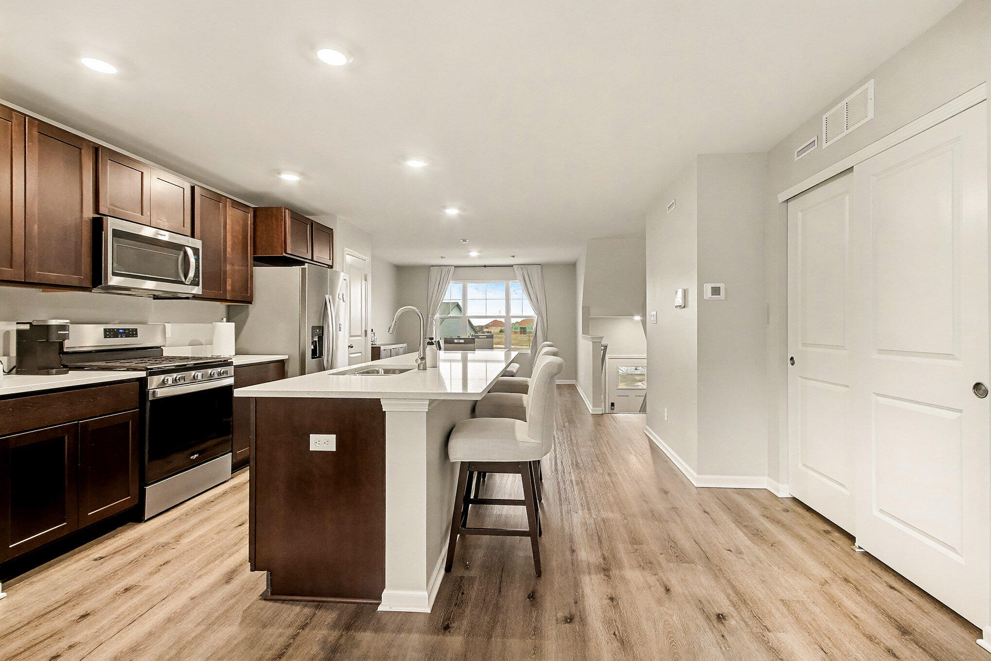 8690 Larkspur Lane St. John, IN 46373 - Photo 5 of 21 a living room with stainless steel appliances granite countertop furniture wooden floor and a view of kitchen