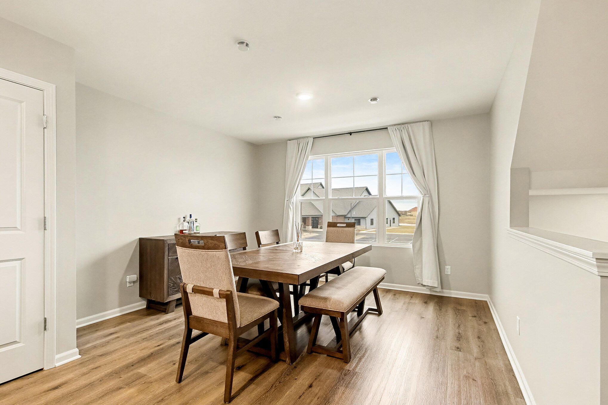8690 Larkspur Lane St. John, IN 46373 - Photo 7 of 21 a view of a dining room with furniture and wooden floor
