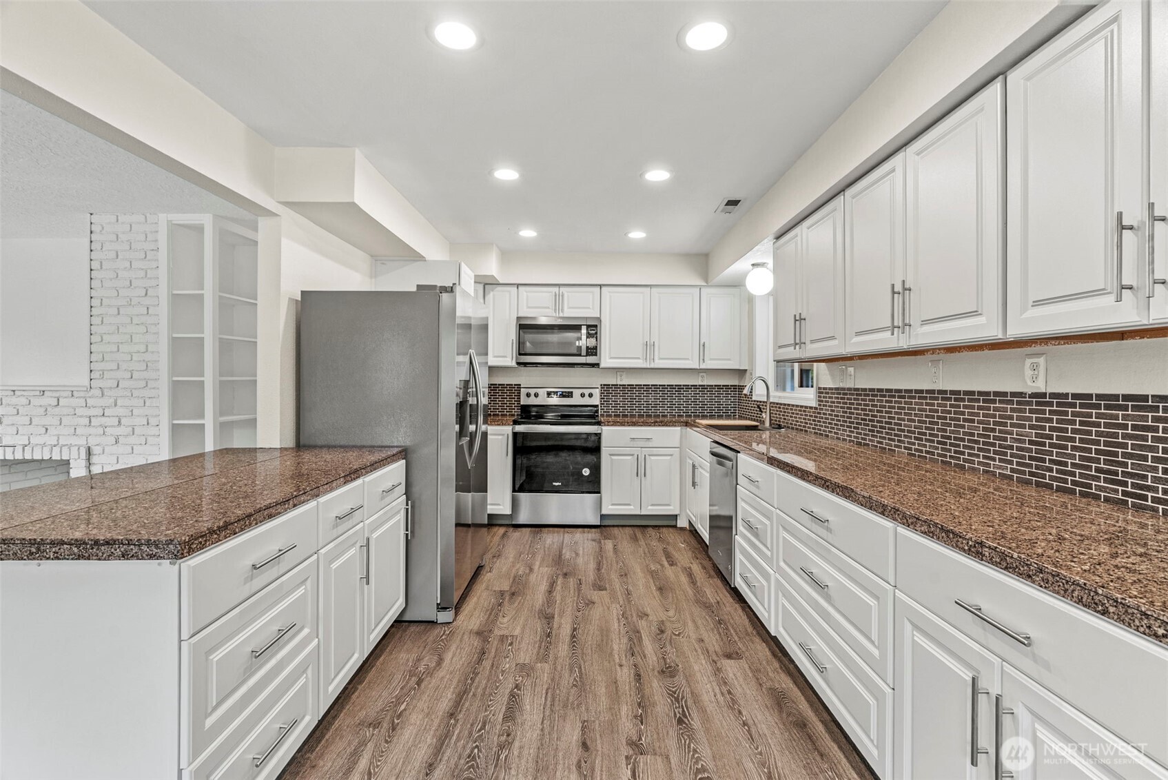 652 Ragland Road Longview, WA 98632 - Photo 12 of 40 a kitchen with kitchen island granite countertop a sink appliances cabinets and counter space