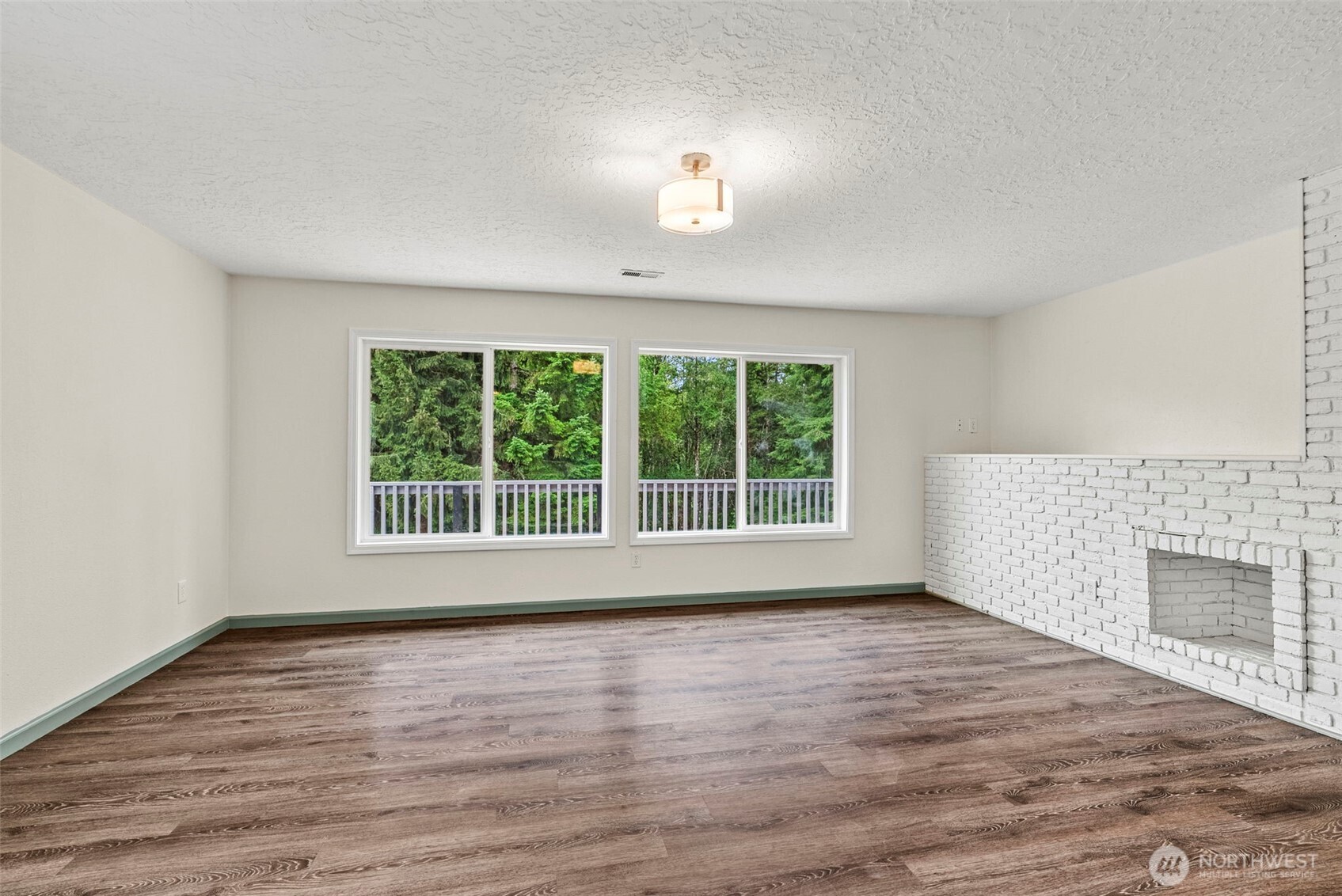 652 Ragland Road Longview, WA 98632 - Photo 6 of 40 a view of an empty room with wooden floor and a window