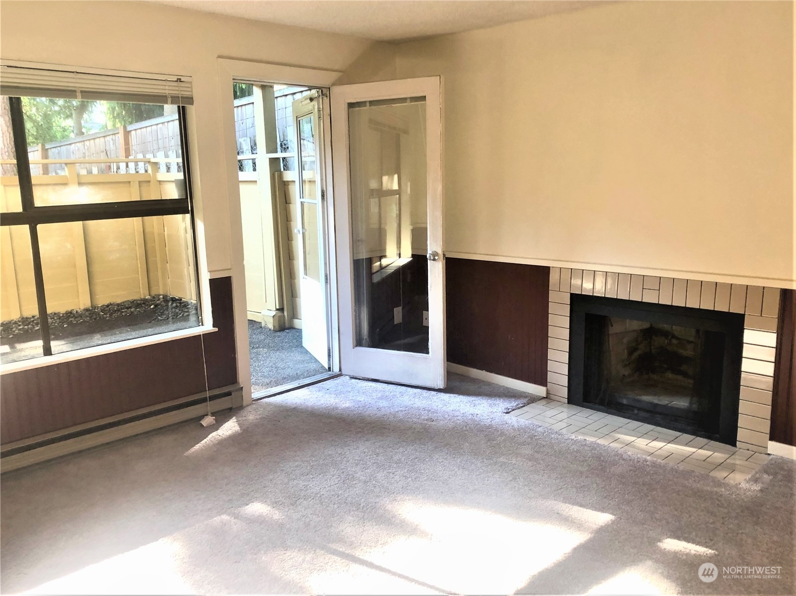 2534 South 317th Street, Unit 103 Federal Way, WA 98003 - Photo 3 of 8 a view of an empty room with window and fire place