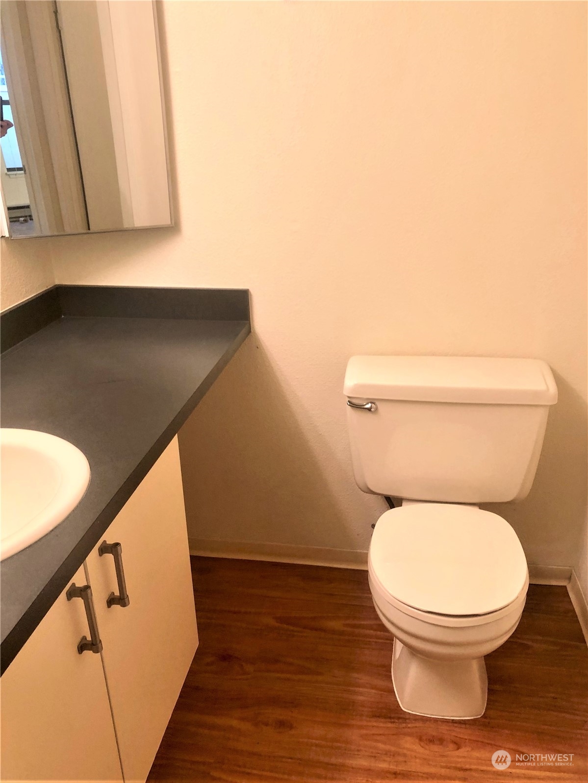 2534 South 317th Street, Unit 103 Federal Way, WA 98003 - Photo 6 of 8 a toilet sitting in a bathroom next to a blue wall