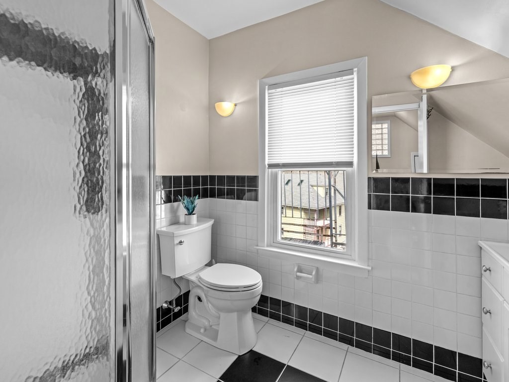 47 R Jamaica Street, Unit 3 Boston, MA 02130 - Photo 14 of 18 a bathroom with a toilet a sink and a window