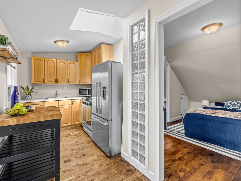 47 R Jamaica Street, Unit 3 Boston, MA 02130 - Photo 9 of 18 a kitchen with granite countertop a refrigerator and a sink