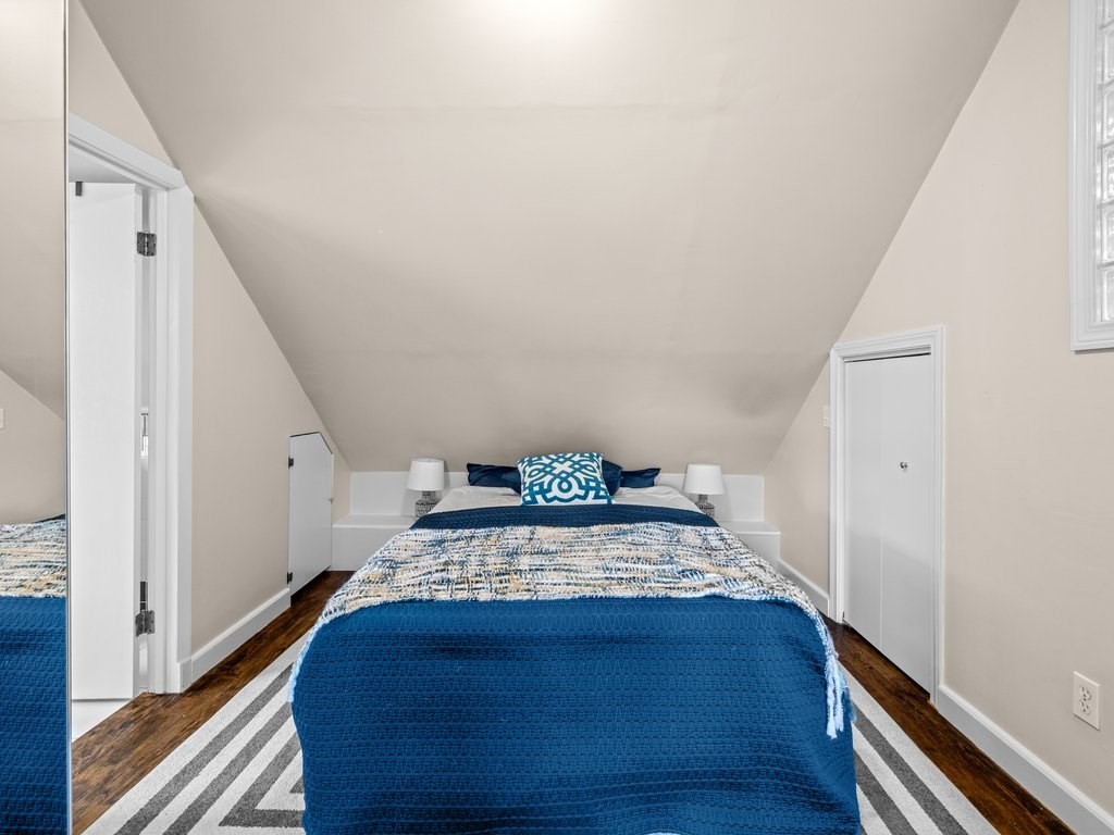 47 R Jamaica Street, Unit 3 Boston, MA 02130 - Photo 10 of 18 a bed sitting in a spacious bedroom next to a hallway