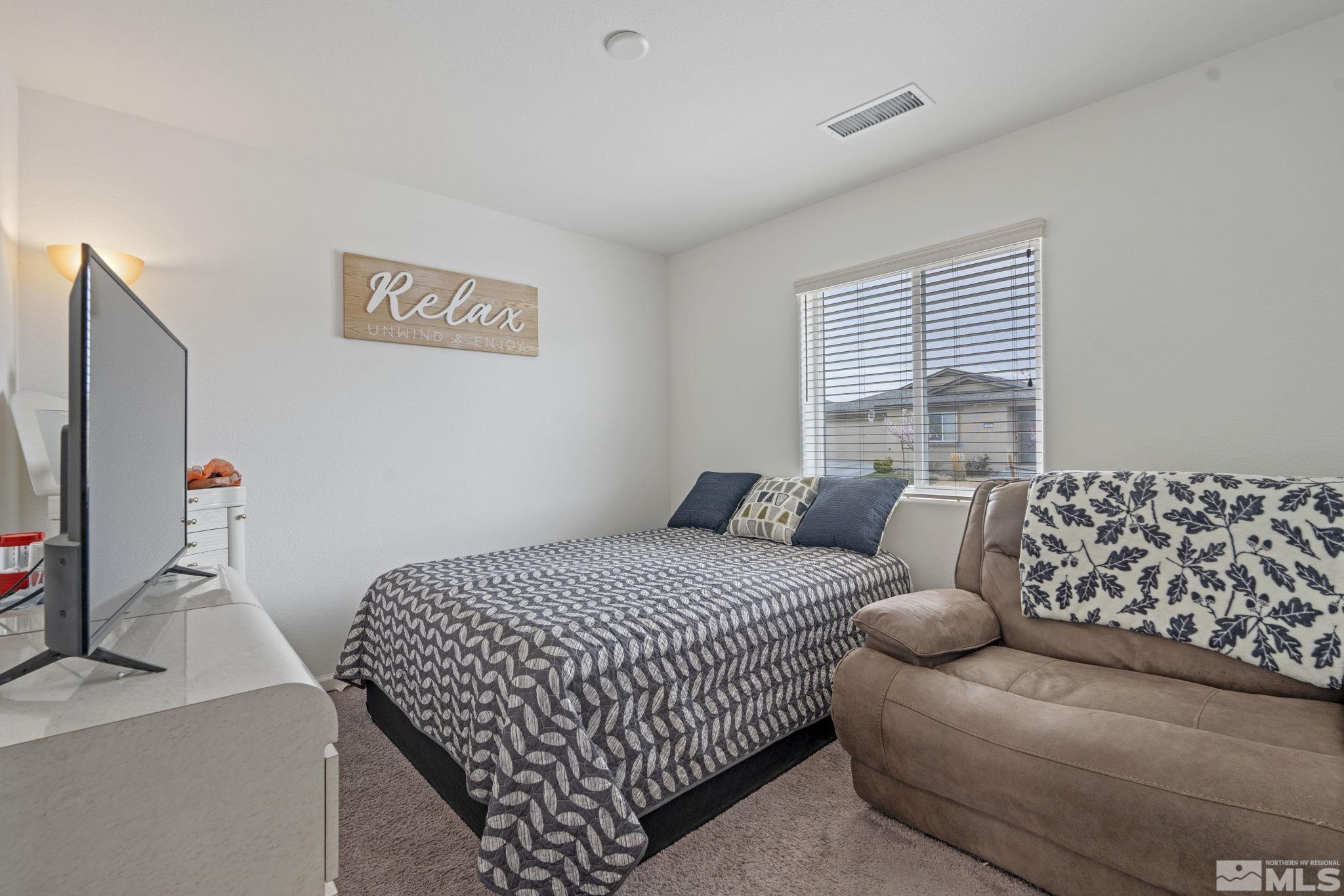 677 Mcgill Drive Reno, NV 89506 - Photo 14 of 29 a bedroom with a bed and a flat screen tv