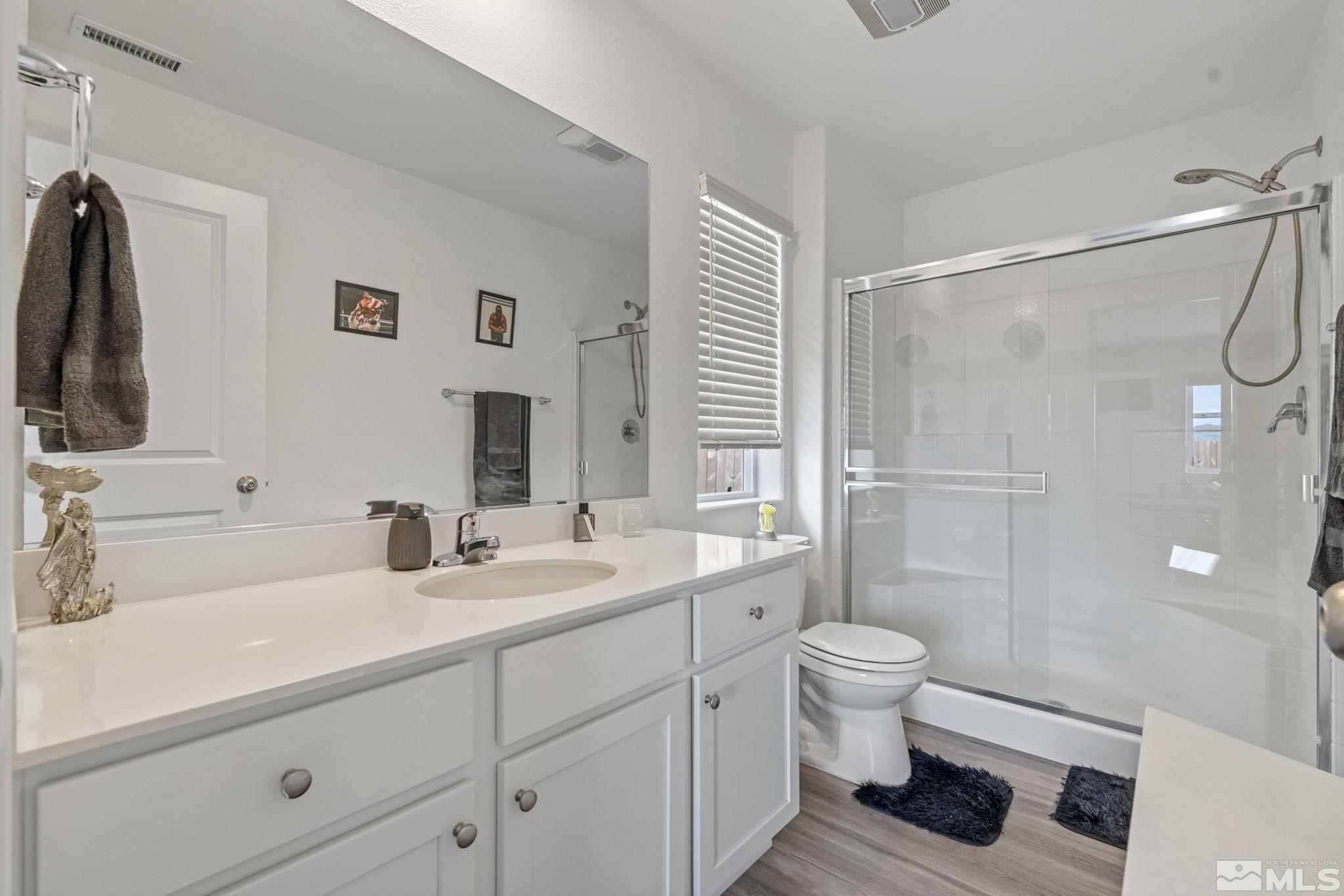 677 Mcgill Drive Reno, NV 89506 - Photo 16 of 29 a bathroom with a sink a toilet and shower