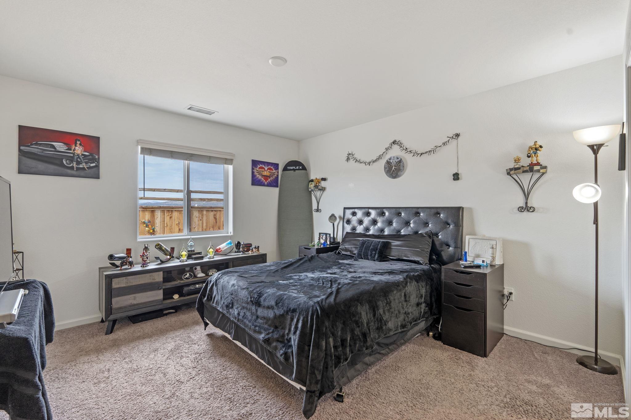 677 Mcgill Drive Reno, NV 89506 - Photo 18 of 29 a bedroom with a bed and a table in it