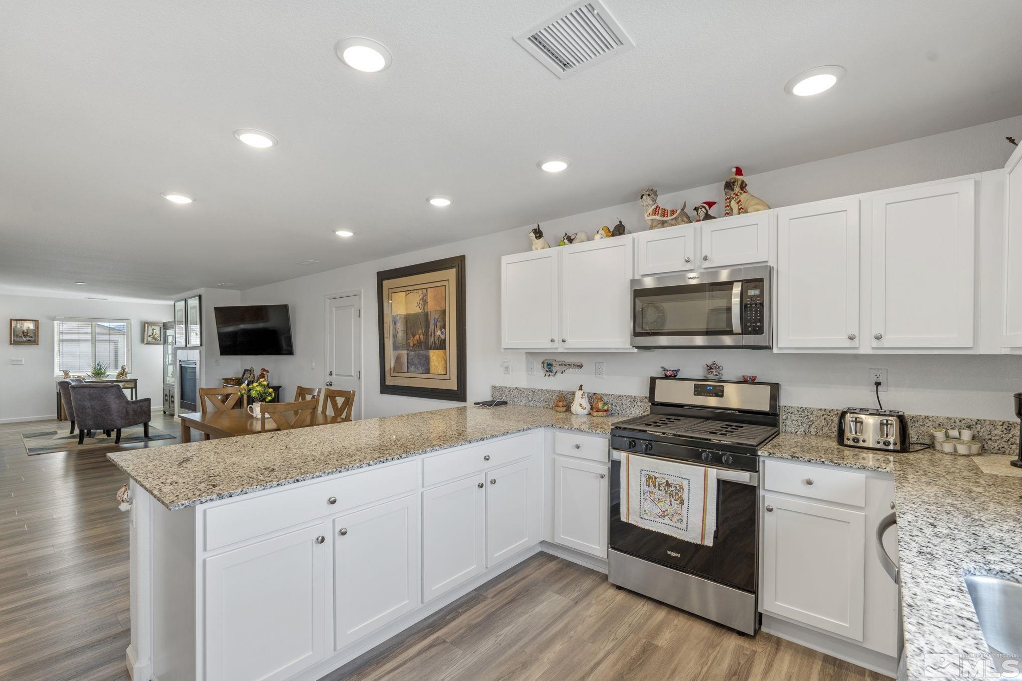 677 Mcgill Drive Reno, NV 89506 - Photo 21 of 29 a kitchen with granite countertop white cabinets and white appliances