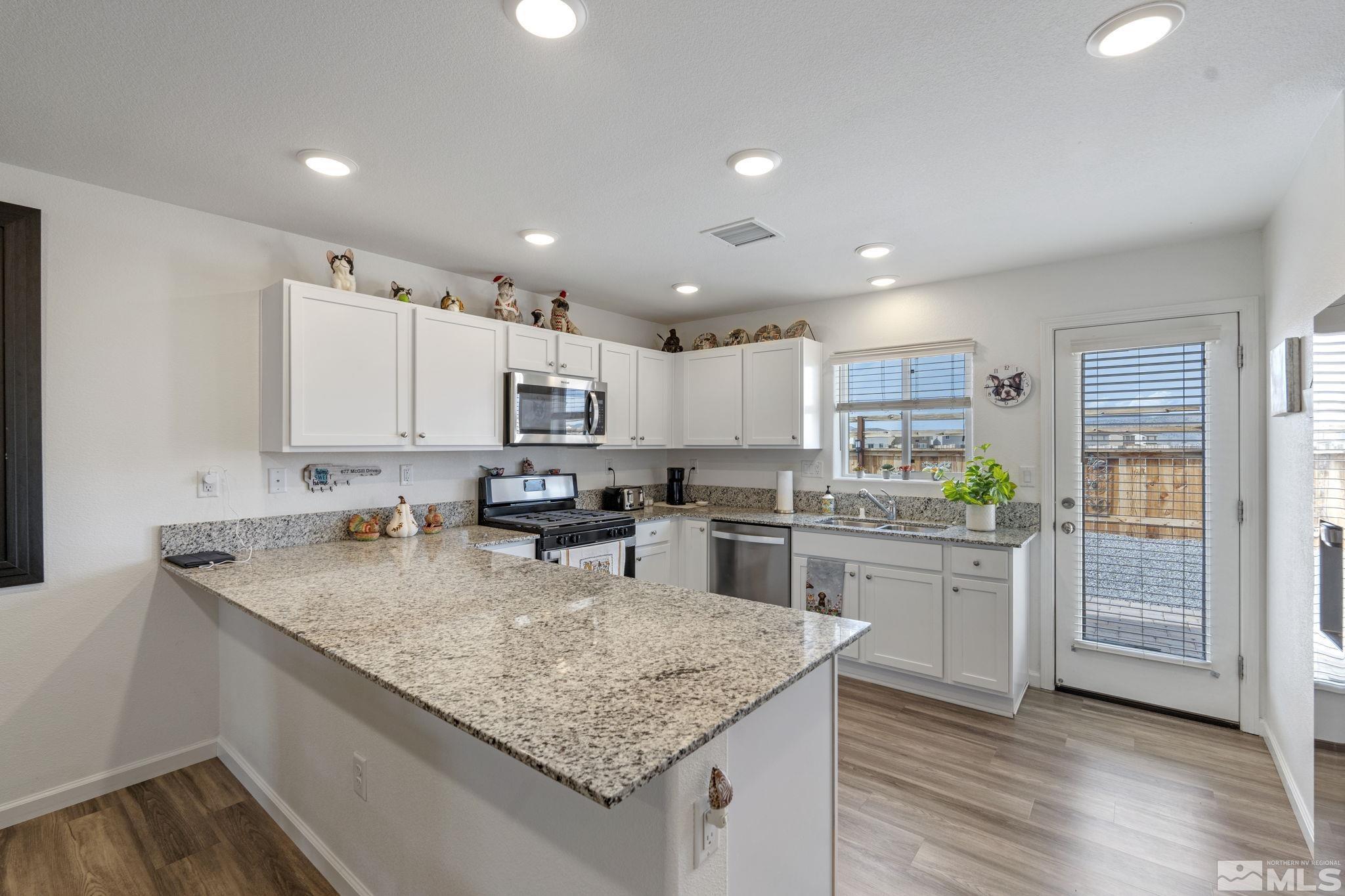 677 Mcgill Drive Reno, NV 89506 - Photo 24 of 29 a kitchen with kitchen island granite countertop a sink cabinets and counter space