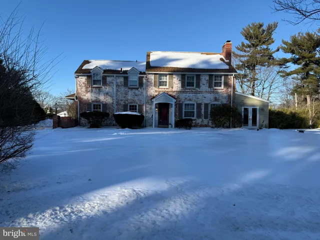 a front view of a building with a garden