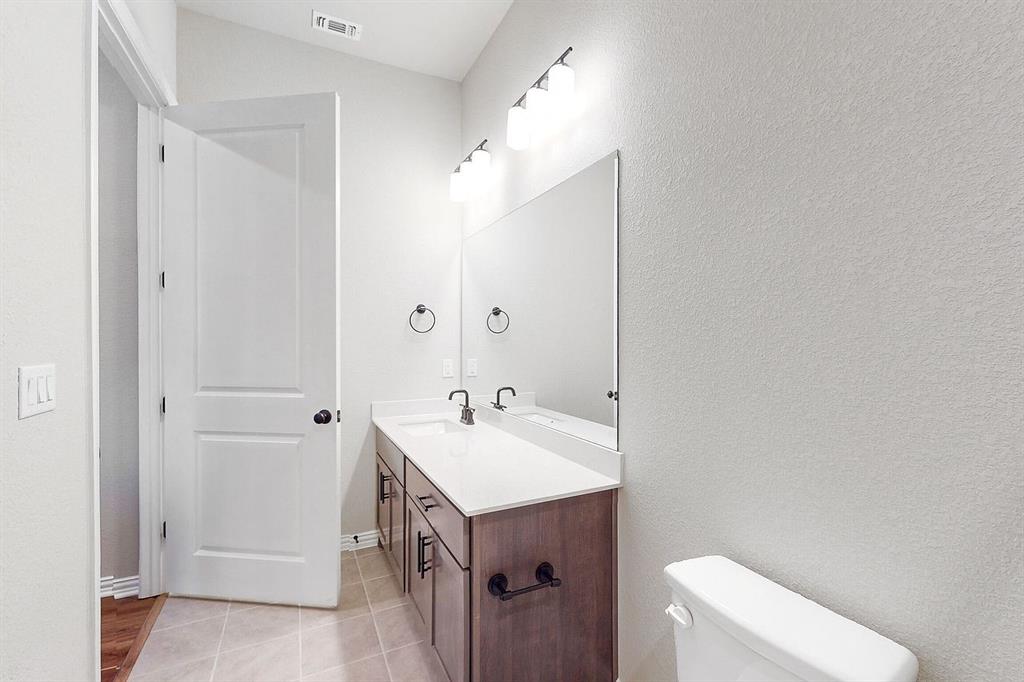4907 Escape Rivera Drive Austin, TX 78747 - Photo 13 of 28 Modern bath with dual sinks offers both style and utility.