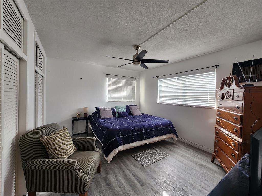 17090 Northeast 14th Avenue, Unit 211 North Miami Beach, FL 33162 - Photo 15 of 26 a bedroom with a bed and a couch