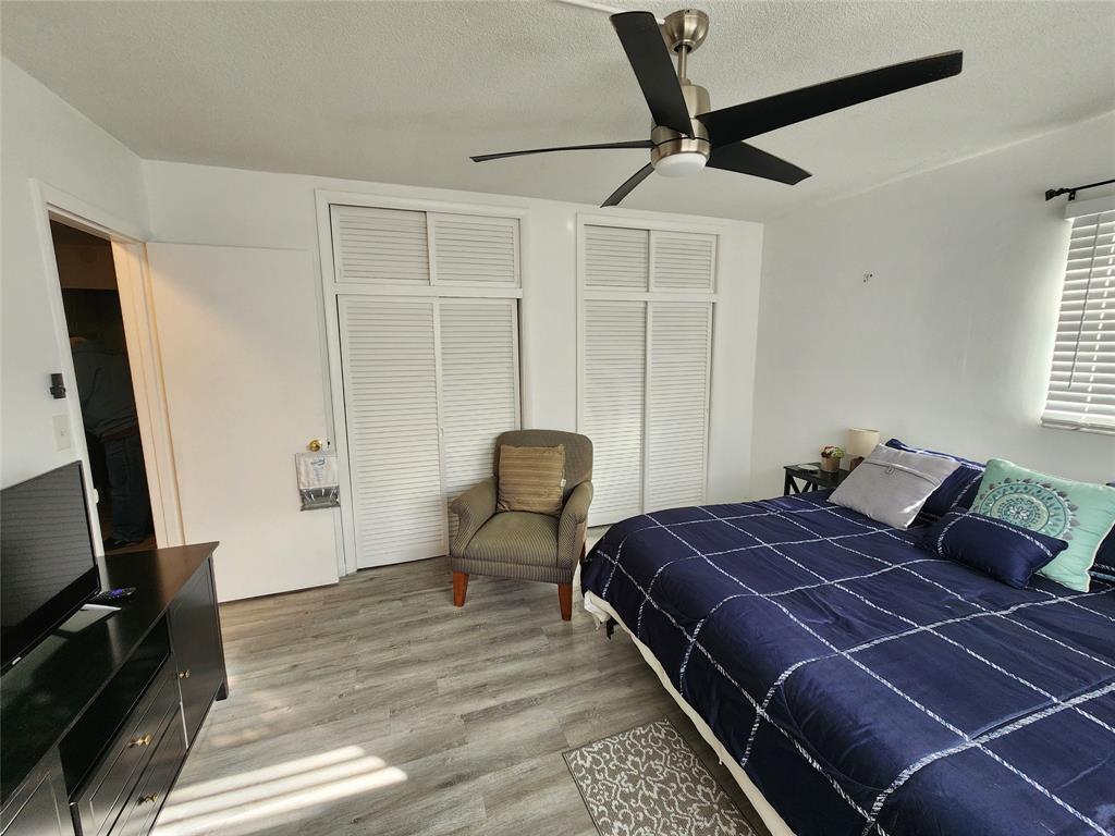 17090 Northeast 14th Avenue, Unit 211 North Miami Beach, FL 33162 - Photo 16 of 26 a bedroom with a bed a desk and chair