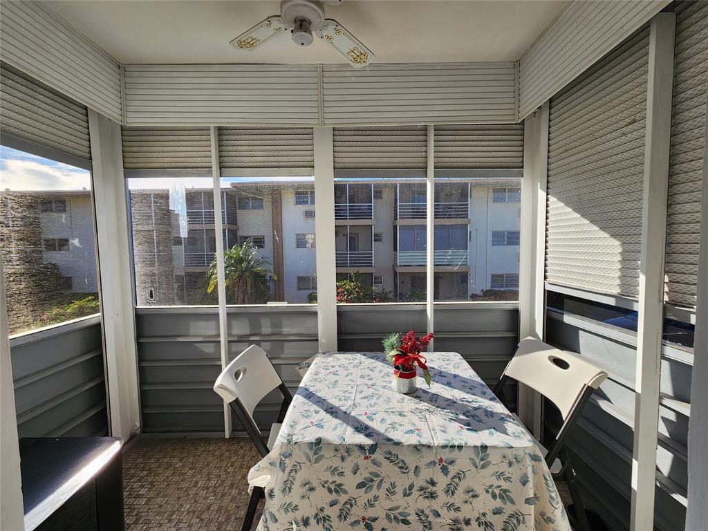 17090 Northeast 14th Avenue, Unit 211 North Miami Beach, FL 33162 - Photo 17 of 26 a balcony with table and chairs