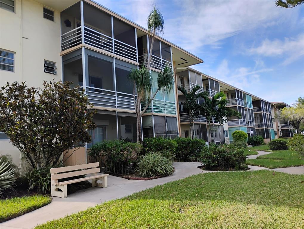 17090 Northeast 14th Avenue, Unit 211 North Miami Beach, FL 33162 - Photo 21 of 26 a front view of a house with a garden