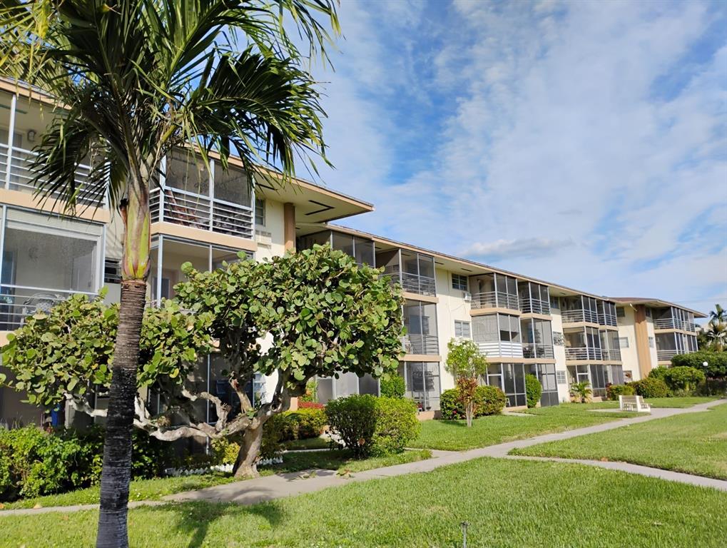 17090 Northeast 14th Avenue, Unit 211 North Miami Beach, FL 33162 - Photo 22 of 26 a front view of a house with garden