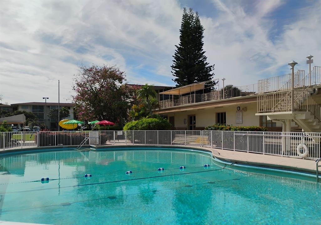 17090 Northeast 14th Avenue, Unit 211 North Miami Beach, FL 33162 - Photo 25 of 26 a view of a house with a backyard and swimming pool