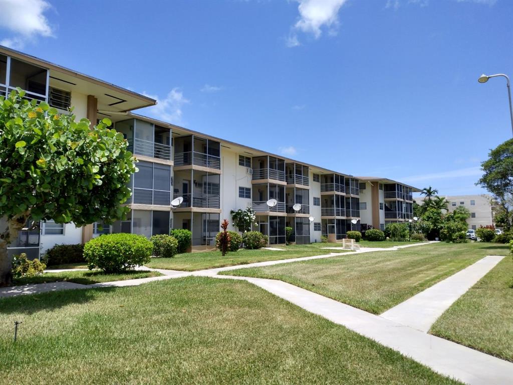 17090 Northeast 14th Avenue, Unit 211 North Miami Beach, FL 33162 - Photo 26 of 26 a view of a building with a yard