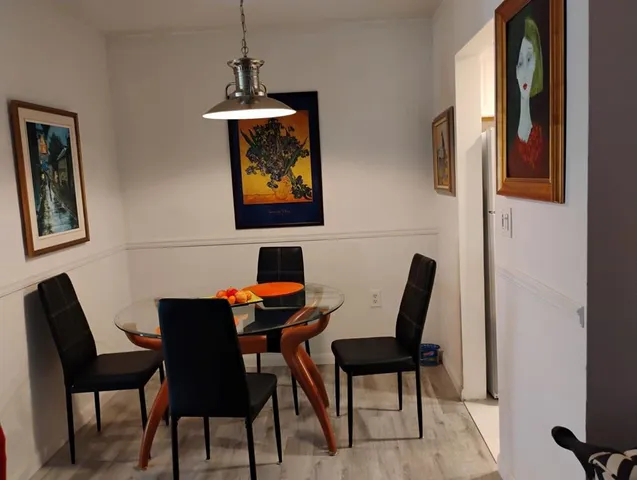 a dining room with furniture and window