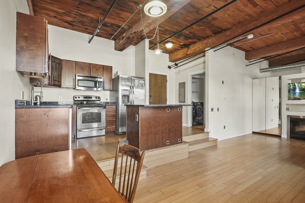 1511 Main Street, Unit C405 Worcester, MA 01603 - Photo 12 of 23 a kitchen with stainless steel appliances granite countertop a refrigerator a stove top oven a sink and dishwasher