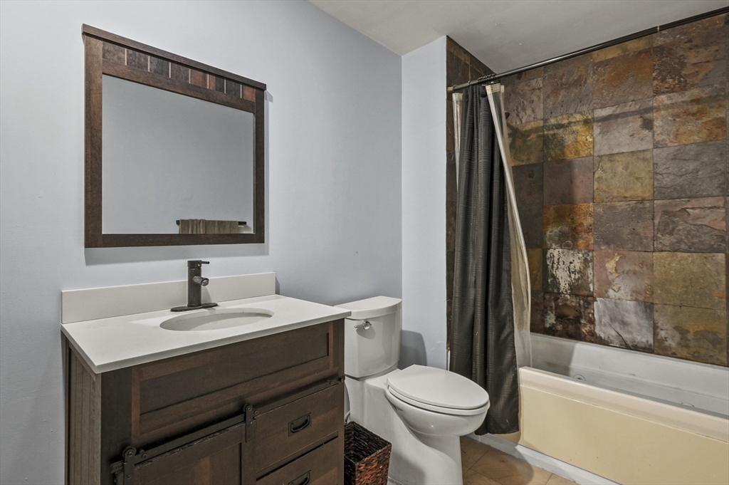 1511 Main Street, Unit C405 Worcester, MA 01603 - Photo 13 of 23 a bathroom with a sink toilet and shower