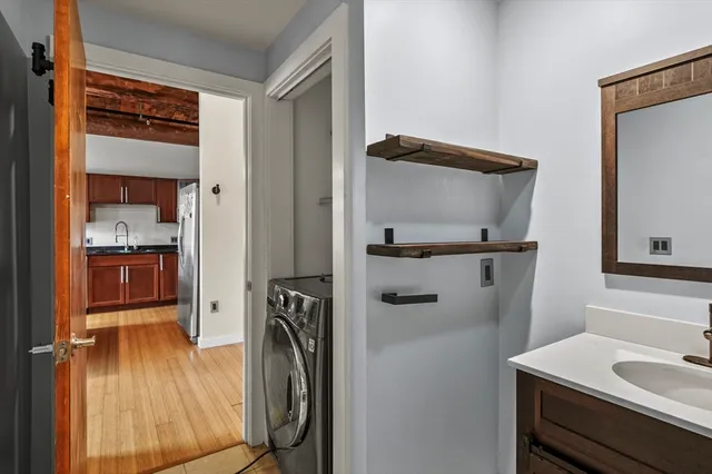 a bathroom with a sink a mirror and shower