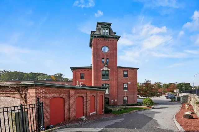 a view of a brick building next to a yard