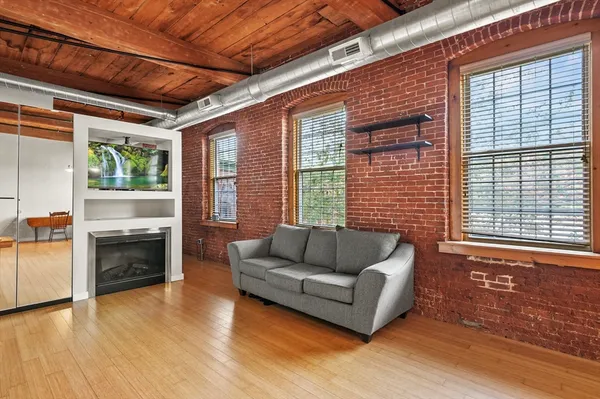 a living room with furniture and a fireplace