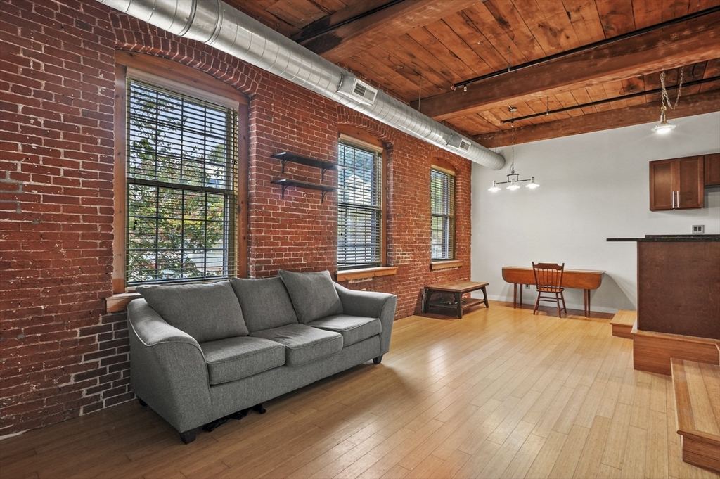1511 Main Street, Unit C405 Worcester, MA 01603 - Photo 5 of 23 a living room with furniture and a flat screen tv