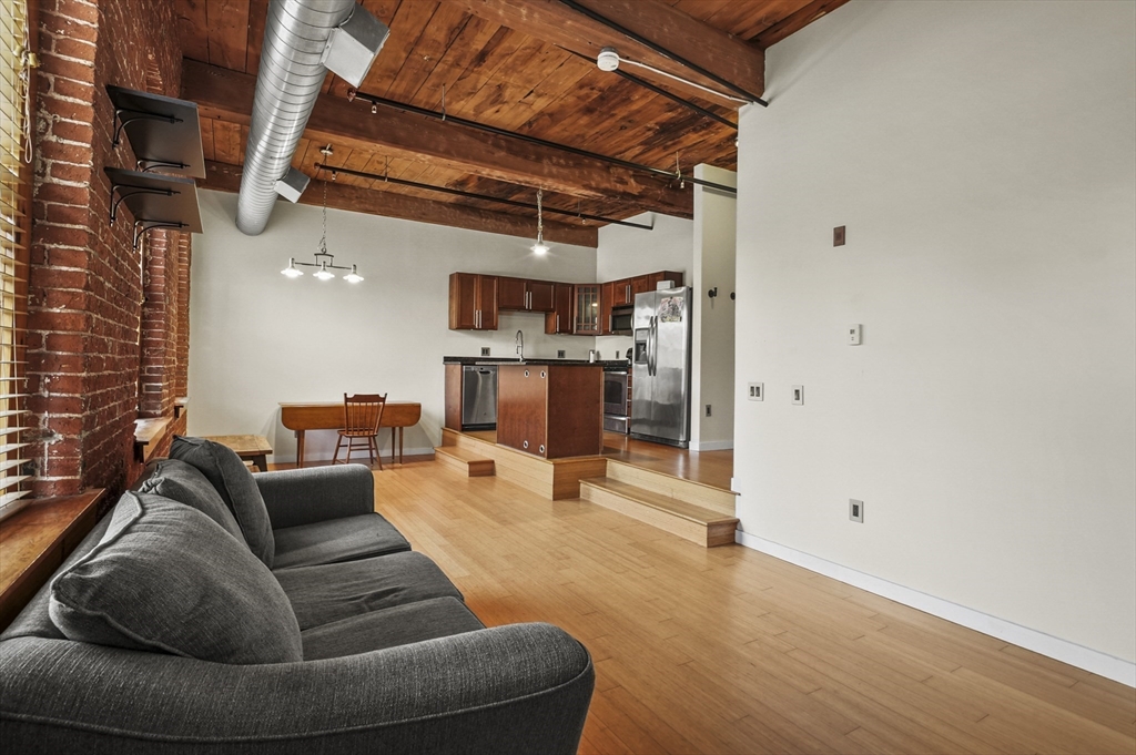 1511 Main Street, Unit C405 Worcester, MA 01603 - Photo 6 of 23 a living room with furniture and a fireplace