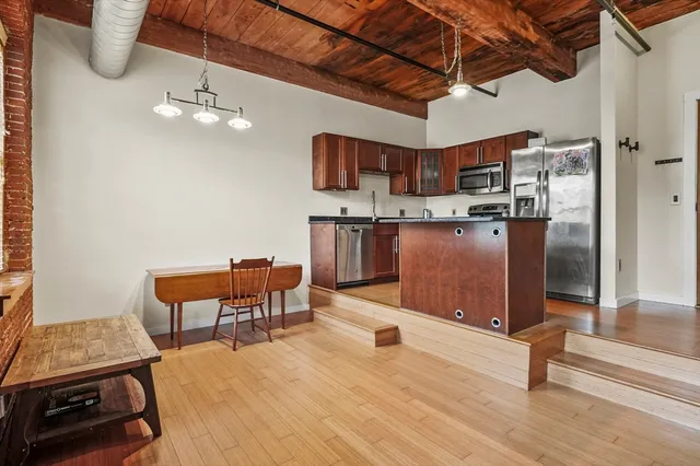 a view of a dining room with furniture a chandelier and wooden floor