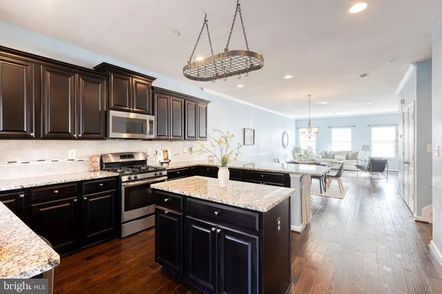 a kitchen with lots of counter top space a sink appliances and cabinets