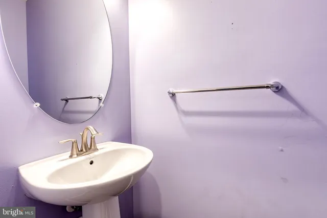 a bathroom with a sink a mirror and vanity